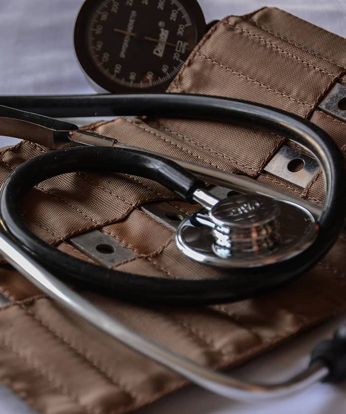 A close up of a stethoscope on a leather satchel