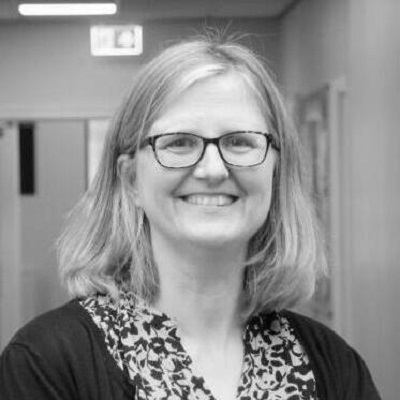 Professional headshot of Sara Fovargue, a woman with shoulder-length blonde hair and glasses, smiling at the camera