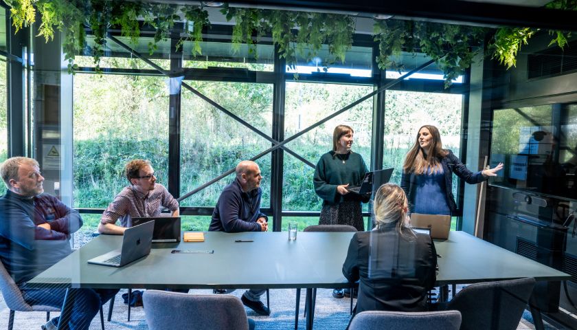 Several people in a LENS meeting room