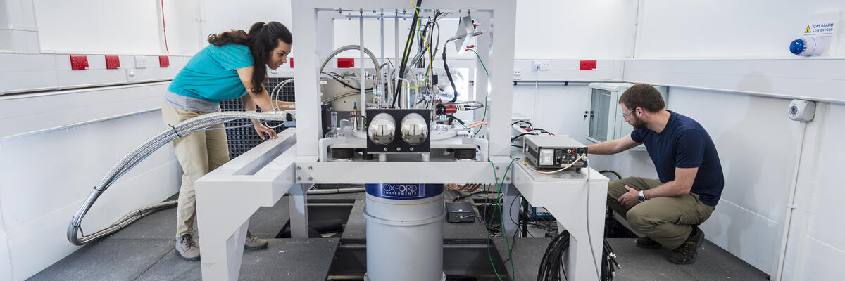 Two research students using technical equipment in a laboratory