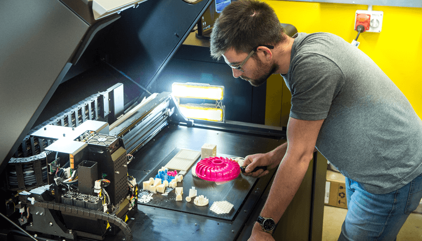 A man working at a 3d printer