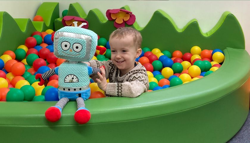Ethan playing in the ball pool with Beep Beep