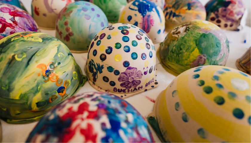 A vibrant collection of BeeBoxes painted by children during a science engagement day in Lancaster