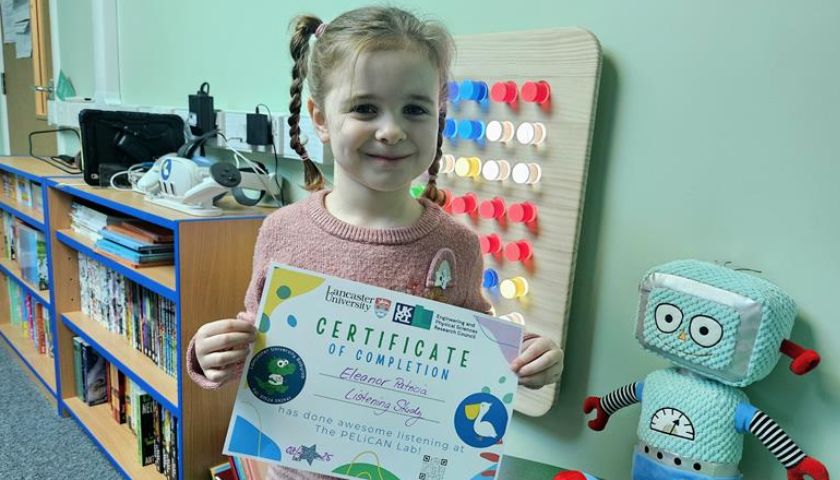 Claire's daughter holding a certificate