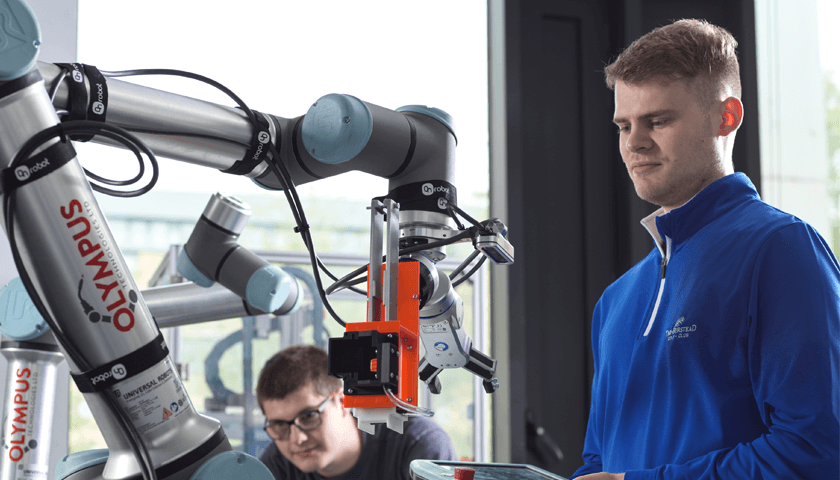 A student working on a robotics arm