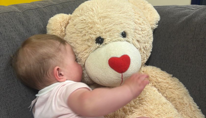 Rose cuddling a giant teddy