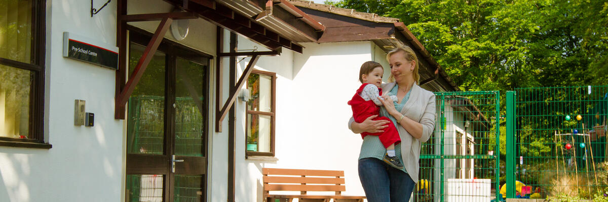 A mother and child leaving the University preschool