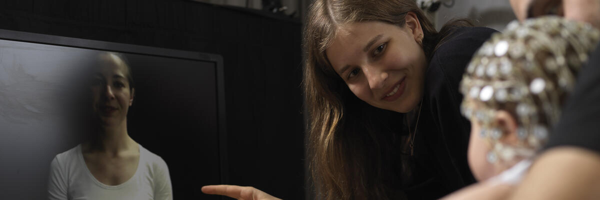 An academic conducting an eye-tracking experiment on a baby