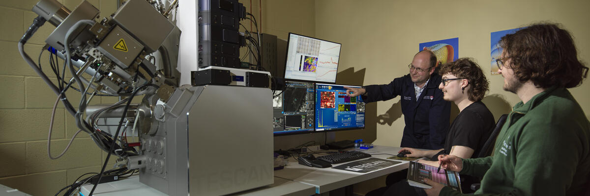 Students and an academic using an SEM