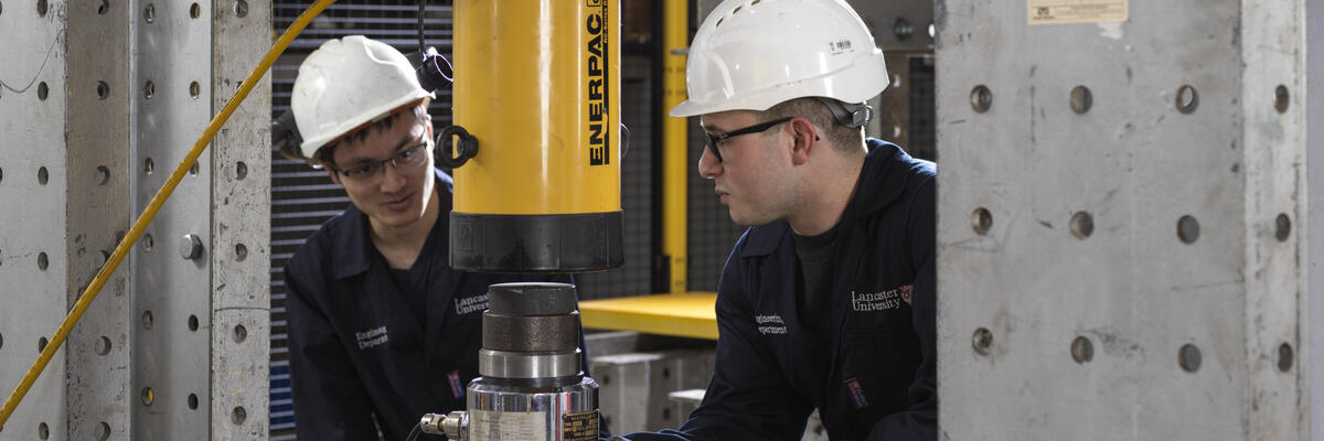 Two students working on the strong floor in Engineering One