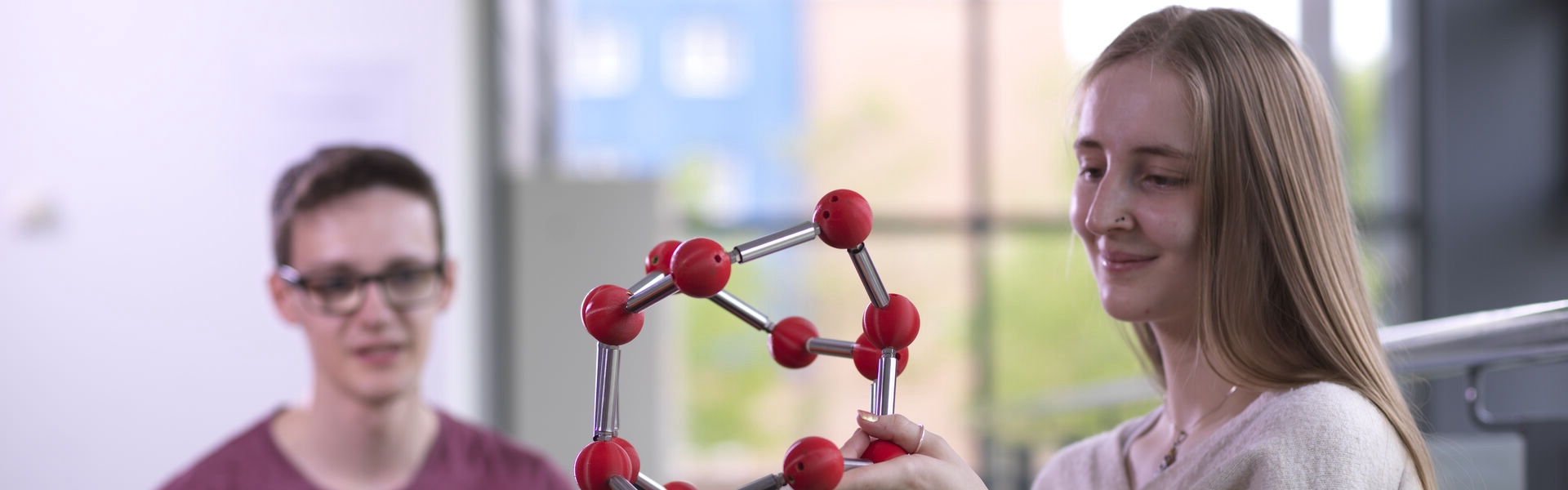 Two students observing mathematical equipment