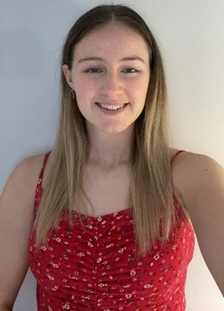 Jessica Andrew, a woman in a red top smiling at a camera