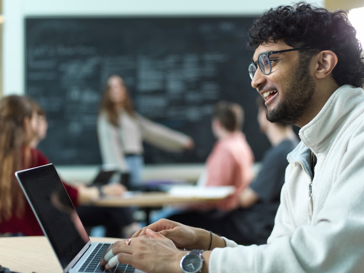 Students in a lecture working on laptop