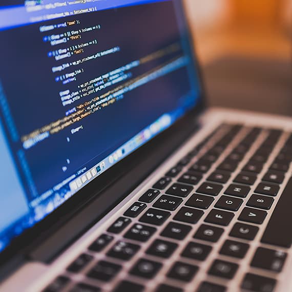 A laptop displaying some code