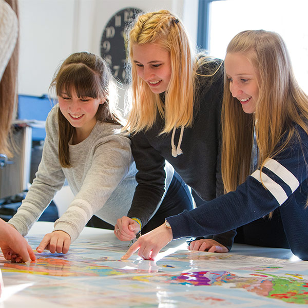 Three people examining a map