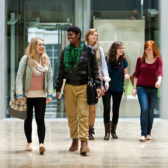 Students walking through a building atrium