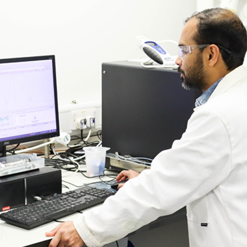 An academic in a lab working on a computer