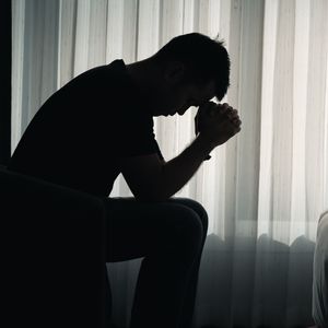 A man with his head in his hands