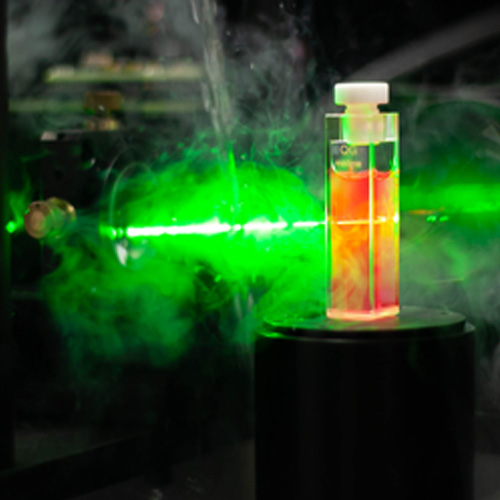 A laser beam passing through an orange vial