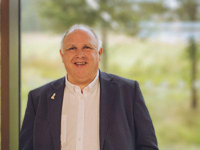 A portrait photograph of Alastair Richards, Chief Executive, North West Cancer Research