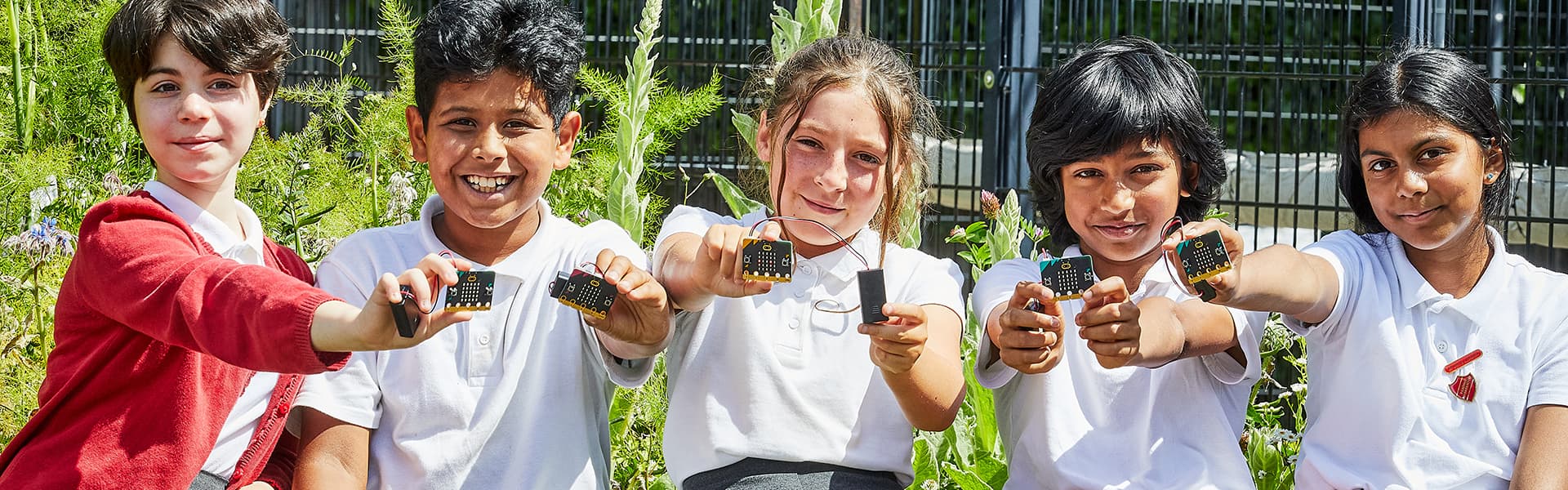 A group of primary school children with Micro:bit single board computers