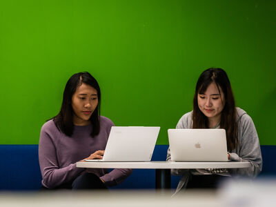 Two students working on laptops