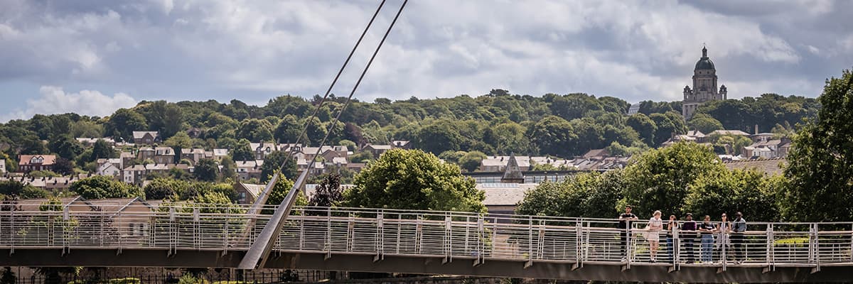 Lancaster Millennium bridge with a view of Ashton Memorial in the background