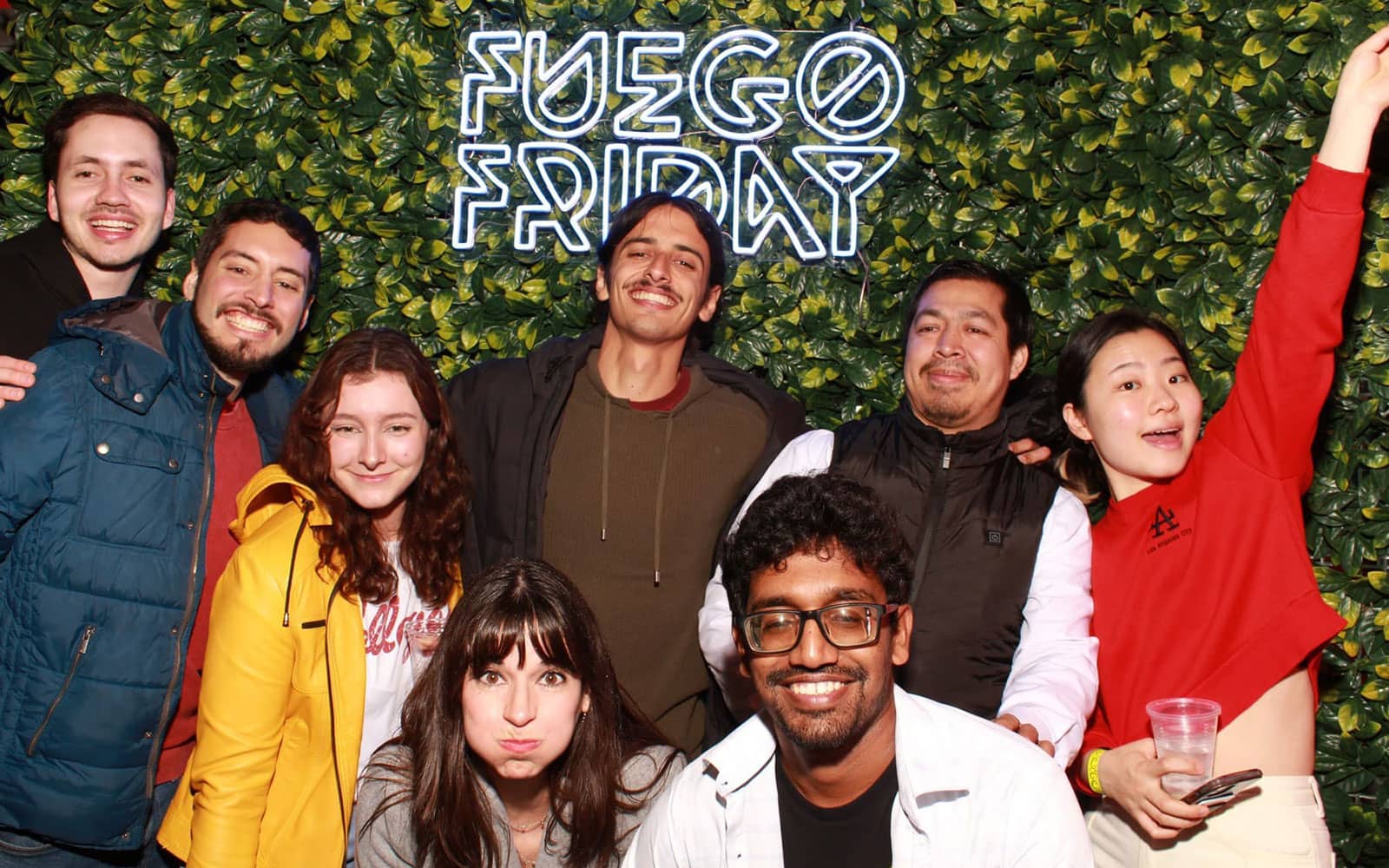 Group of students smiling and pulling faces under a "Fuego Fridays" sign in Missouri, USA