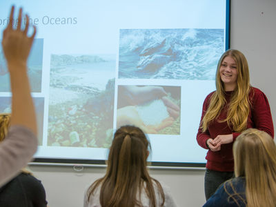 A woman on a Lenovo laptop.