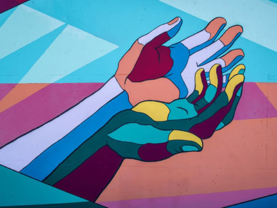 two entwined multi-coloured hands