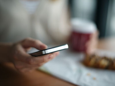 A man texting in a restaurant.