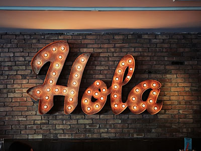 A big neon saying saying Hola.