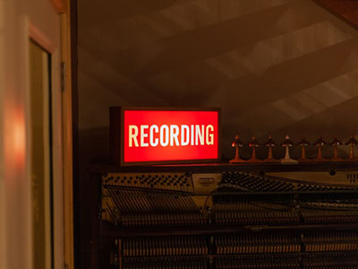 A lit up sign saying Recording.