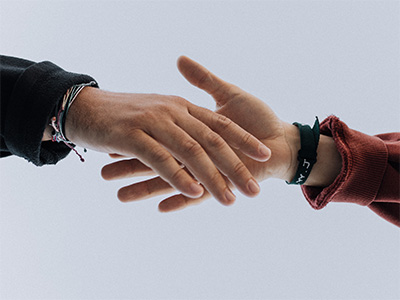 Two hands reaching out to each other.