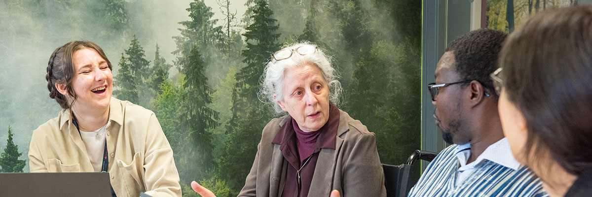 A group of staff members talking at a table.