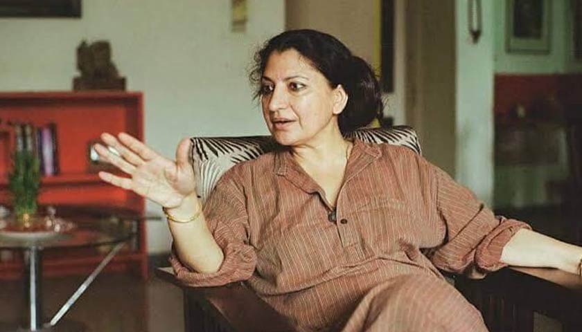 Geetanjali Shree sitting in a chair talking animatedly with hands