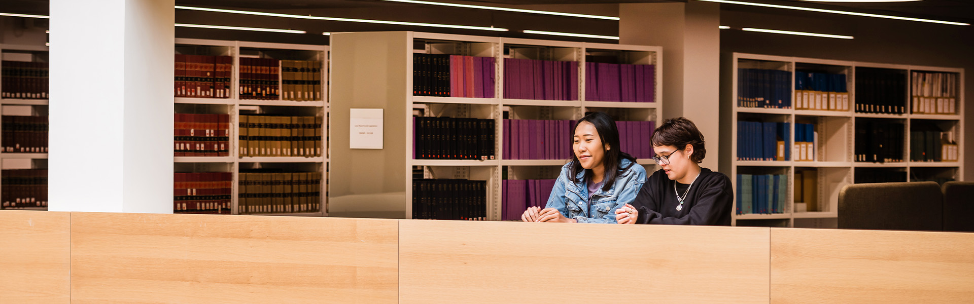 Students looking over a balcony in the Library.