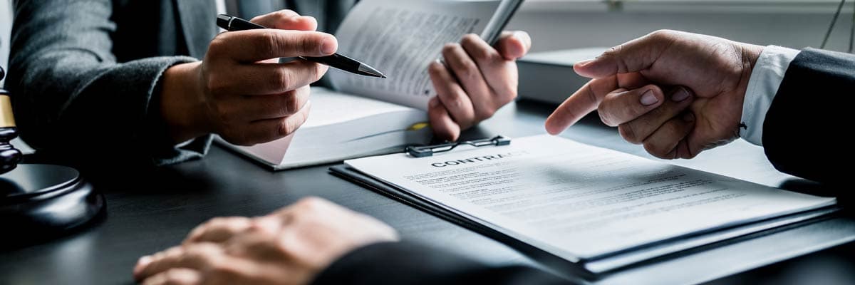 Close up of businessmen or lawyers discussing contract or business agreement