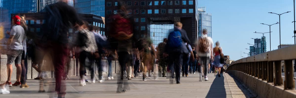 office workers crossing the London bridge in the early morning on the way to the City of London