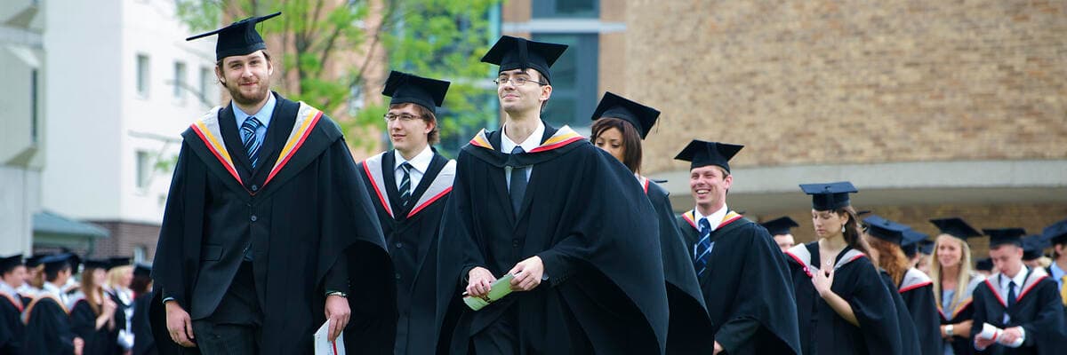 Graduates filing into the great hall for graduation ceremony