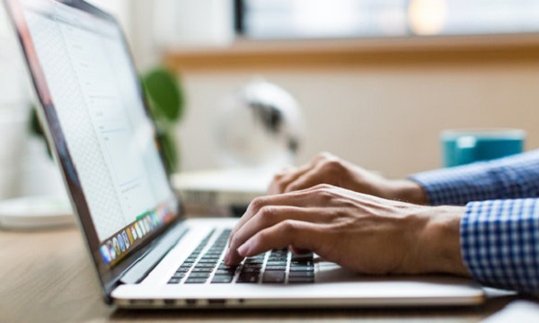 Person typing on laptop computer