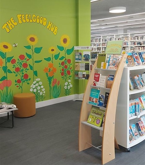 Painted wall of flowers next to the book area supporting wellbeing