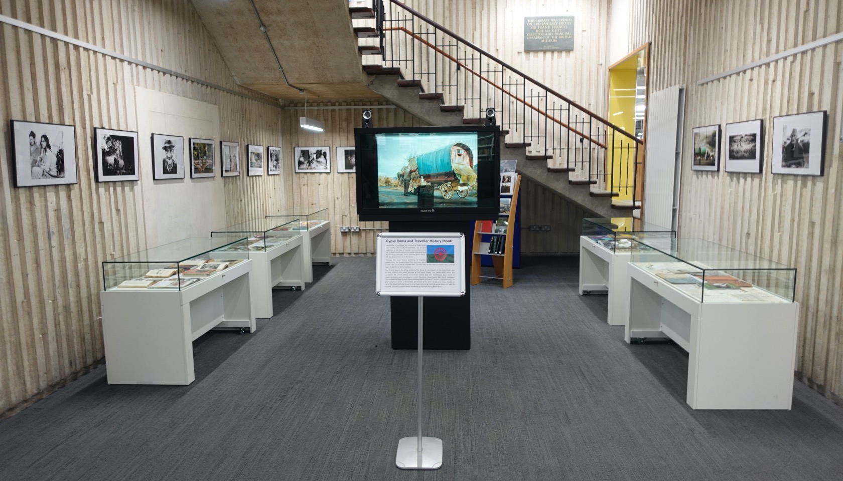 Exhibition with magic box display case in centre, exhibition cases and pictures to either side.