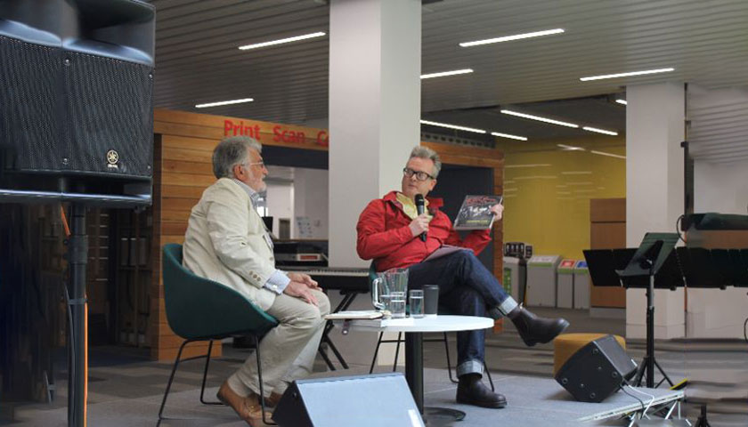 A discussion with Barry Lucas and Andrew Barker on stage in the library
