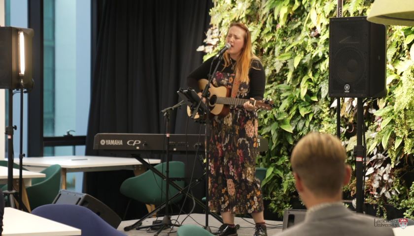 An acoustic guitar performance in the library