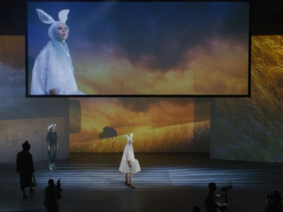 A theatre performance featuring a runway model dressed as a rabbit.