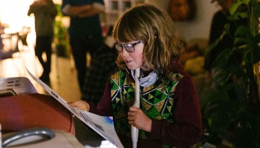 A lady using an Ultrasound tongue imaging tool