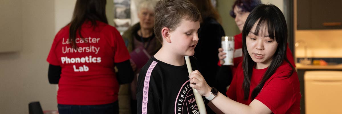 Campus in the city phonetics lab using the ultrasound machine on a young child