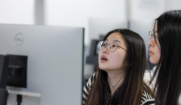 two students looking at a computer 