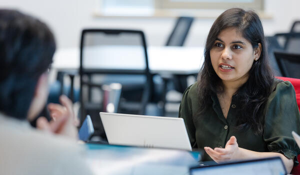 student sat at a table with a laptop